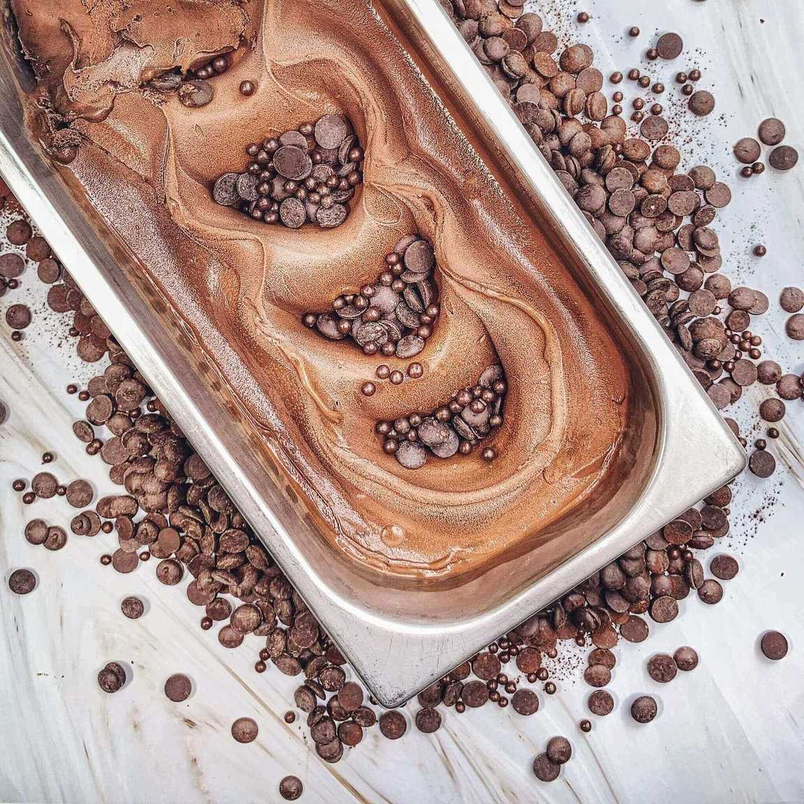 Plant-based vegan chocolate gelato ice cream with a rich, creamy texture, dairy-free and made with cocoa, served as a smooth dark scoop